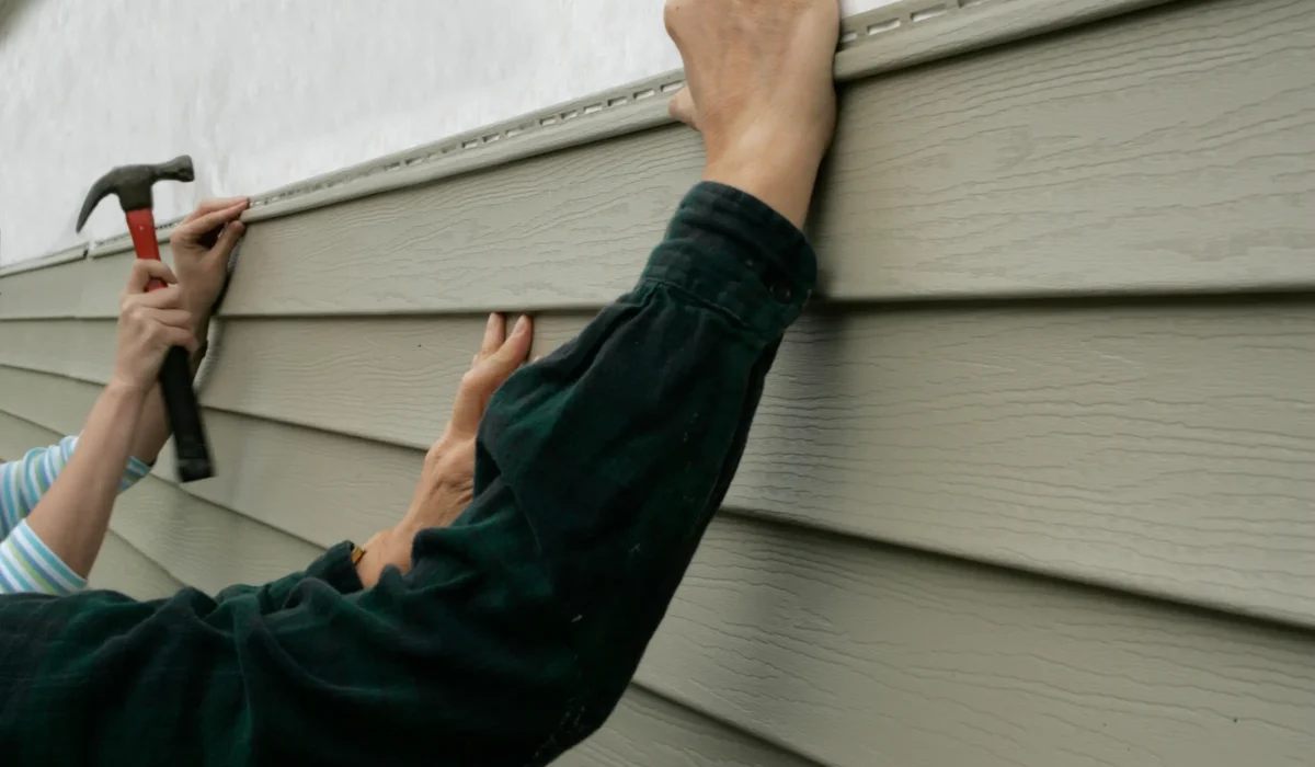 man putting up siding