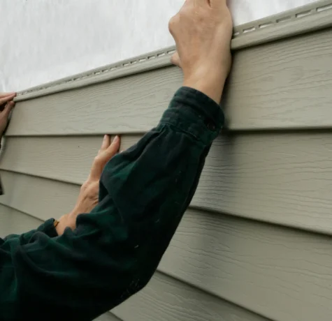 man putting up siding