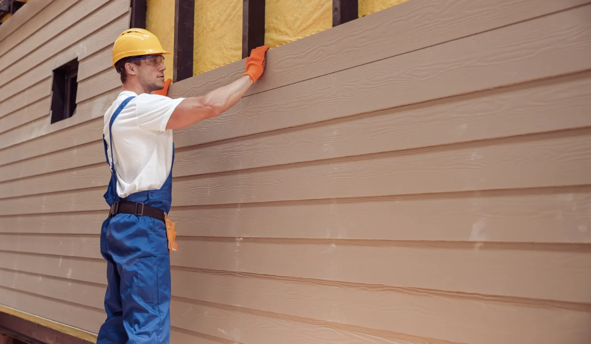 man installing siding