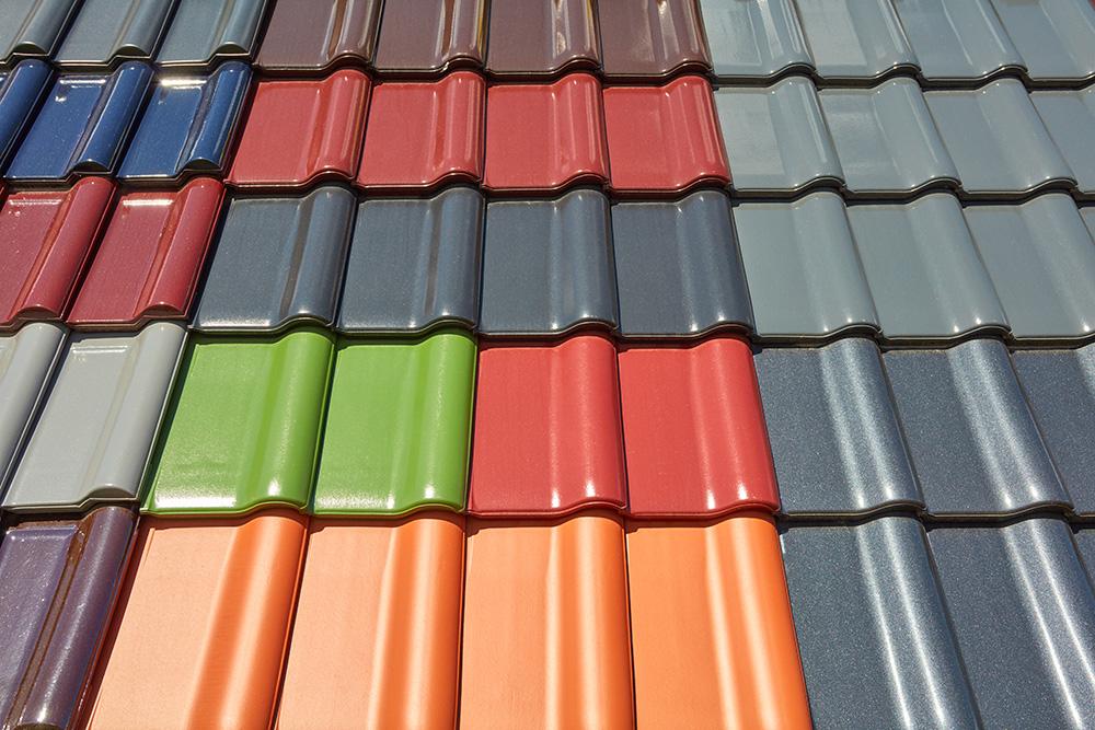 A roof is covered with different colored roof tiles.